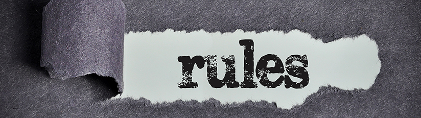 photo of torn paper revealing the word rules