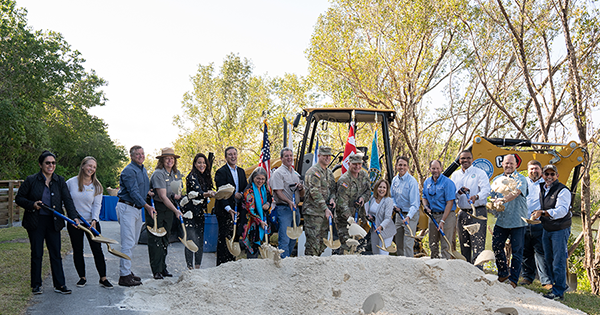 group gathered around dirt pile