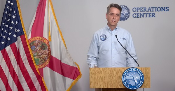 man speaking at podium