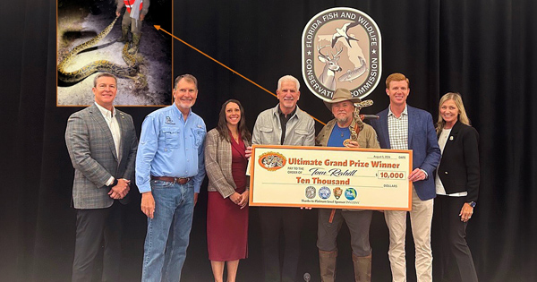 Grand prize winner  posing with a $10,000 prize check