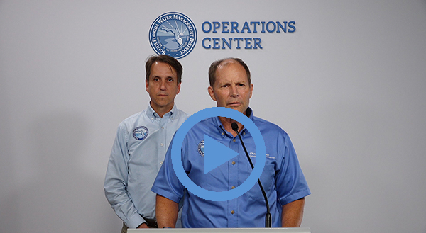 two men standing at podium