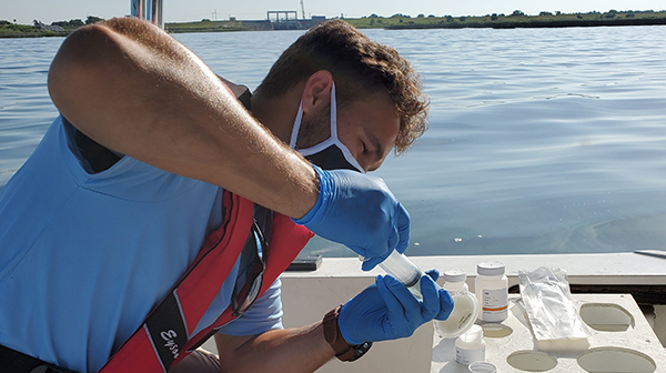 man collecting water sample