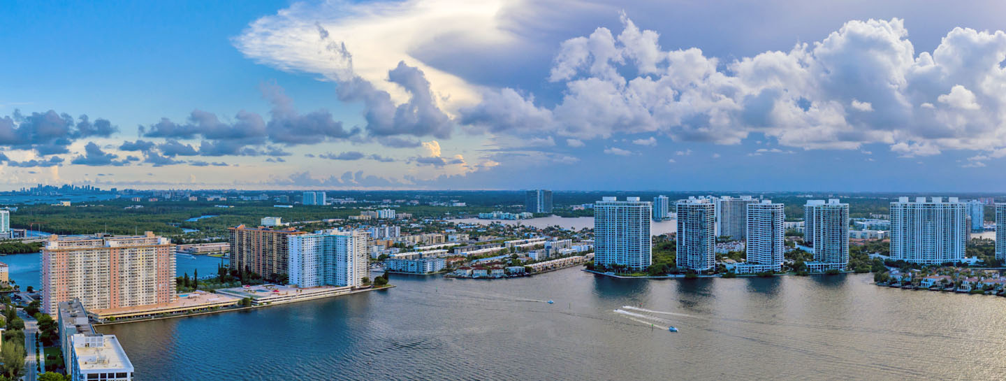 Aerial view of a coastal city with high-rise buildings along a waterway