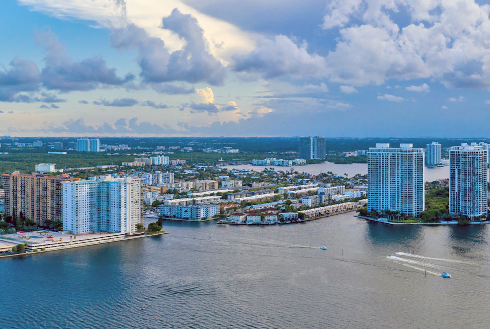 Aerial view of a coastal city with high-rise waterfront buildings