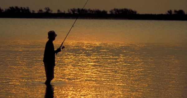 Fishing under dark sky