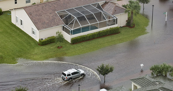 car driving through flooded neighborhood