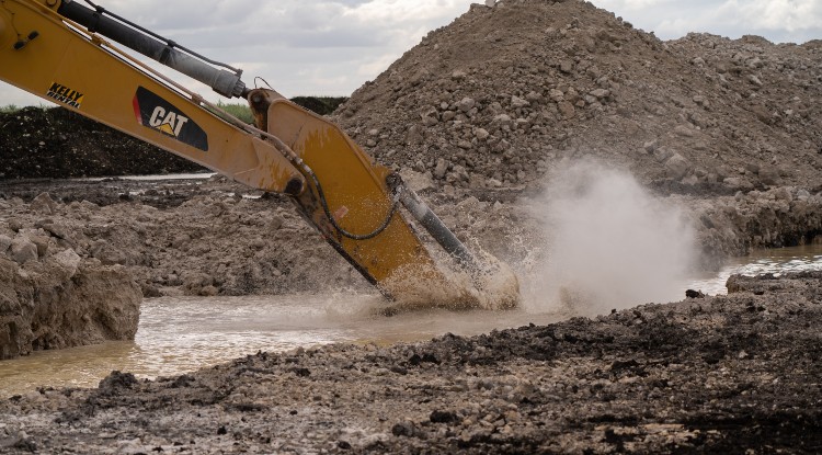 craine digging at construction site