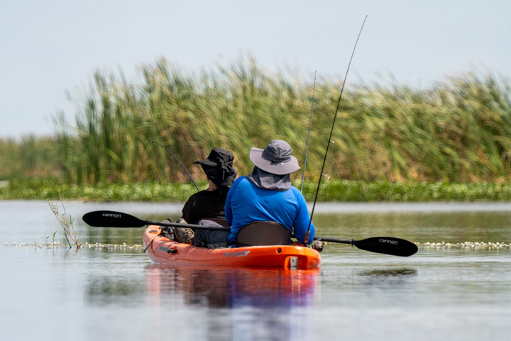A couple kayaking and fishing