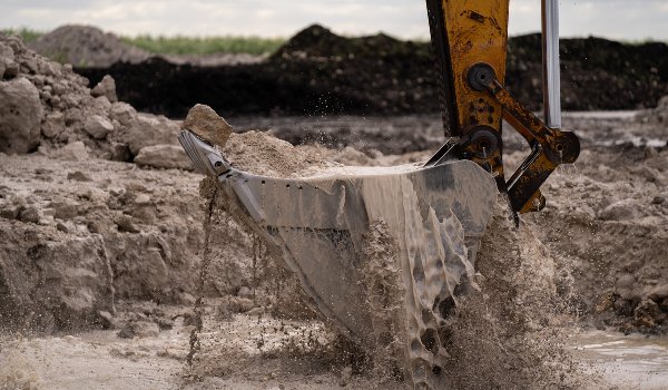 front loader picking up mud and water