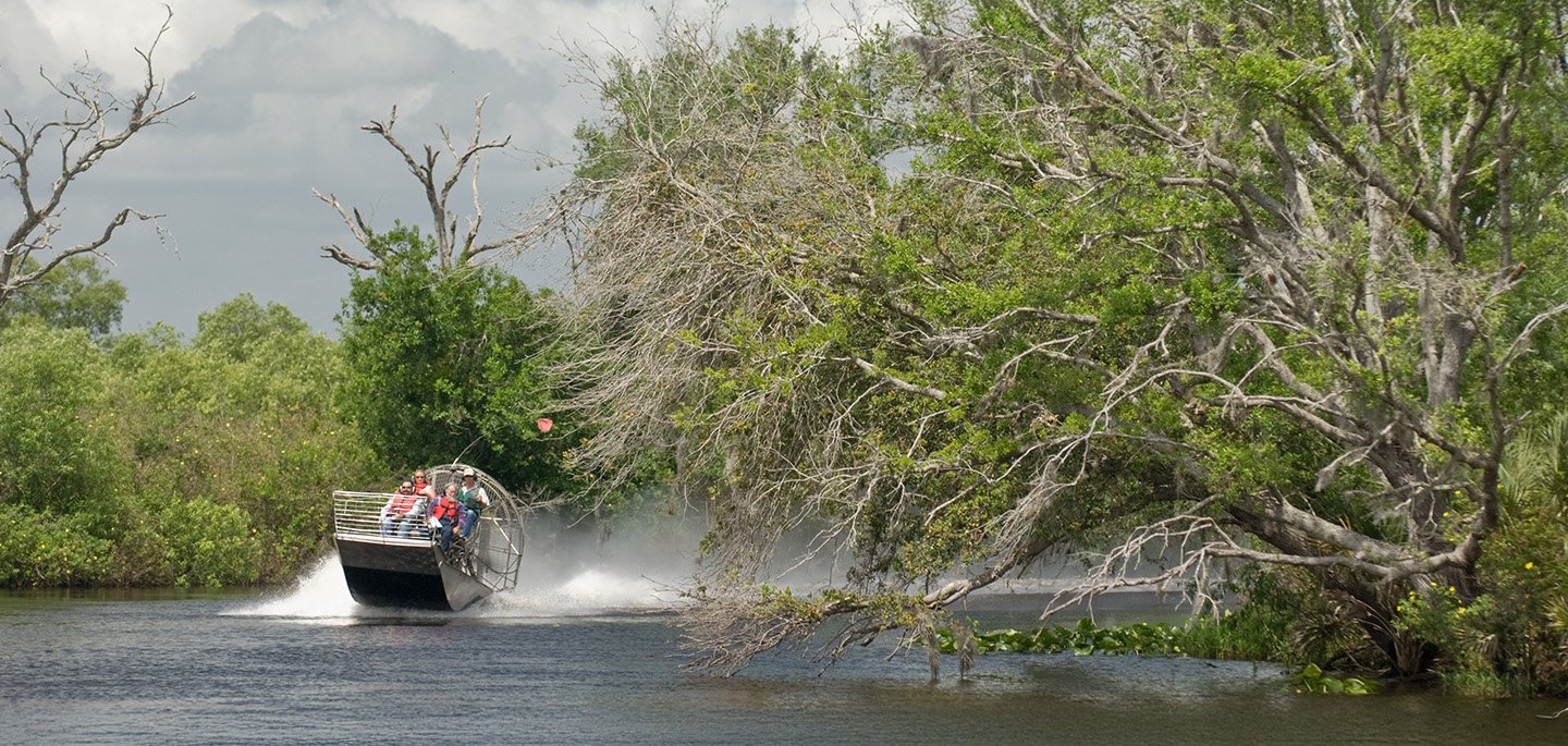 Airboat gliding through a grassy wetland