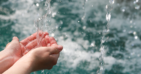 hands underneath running water