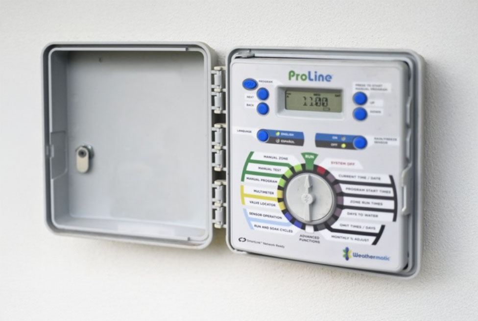 Open irrigation controller mounted on a wall