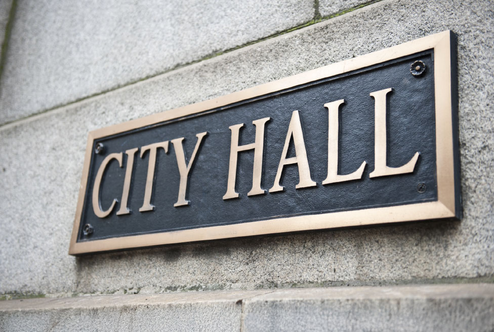 City Hall sign mounted on a wall