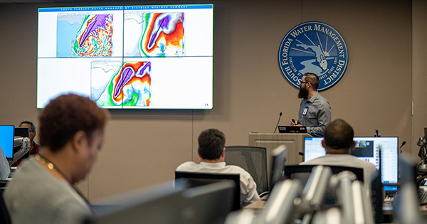 A weather forecasting briefing with model maps on display